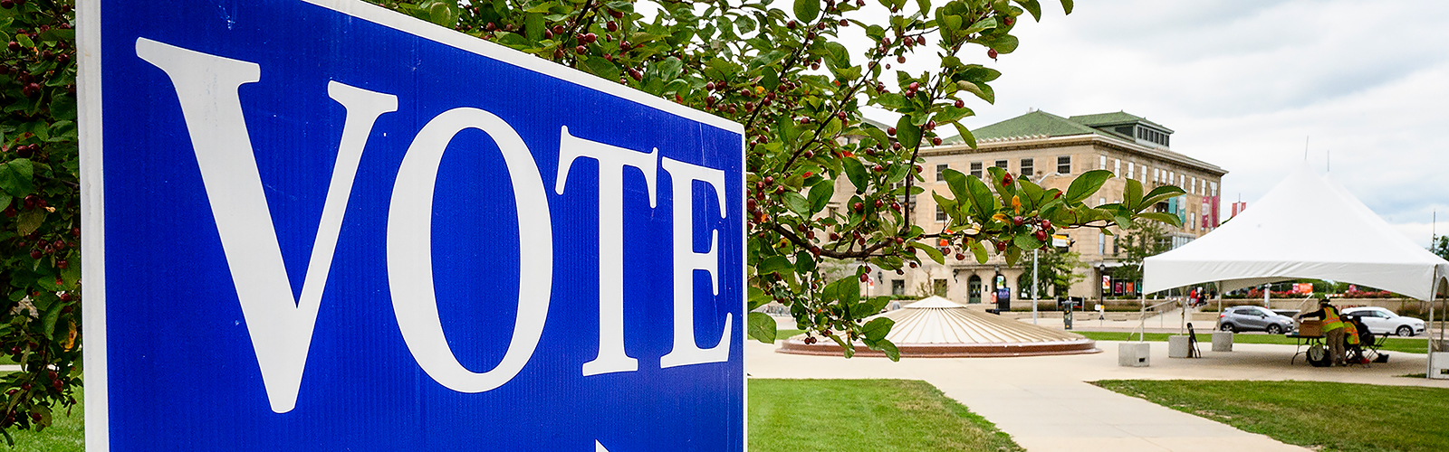 Photo of a blue "VOTE" sign on Library Mall at UW–Madison.